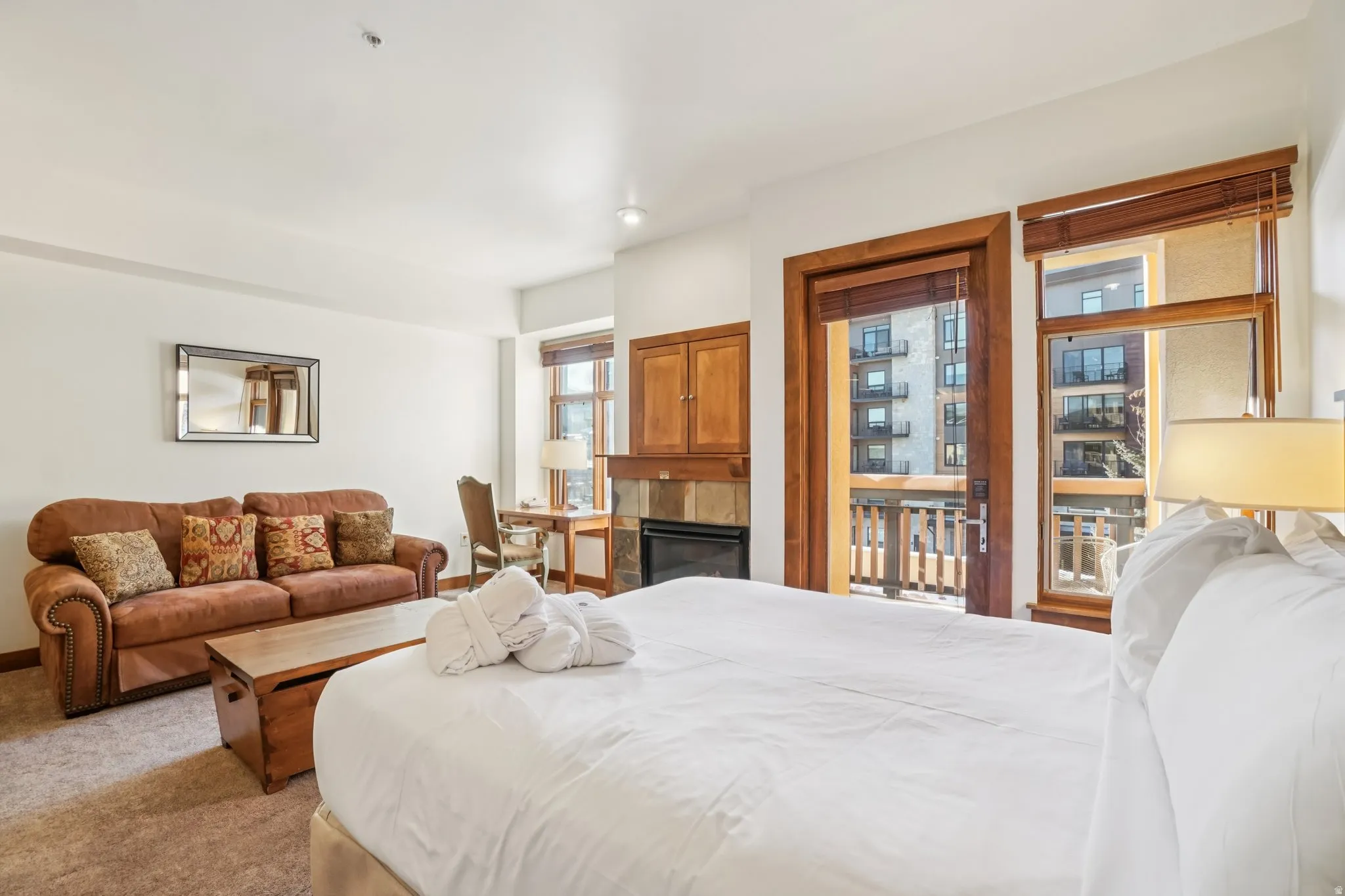 Bedroom featuring a tile fireplace and carpet