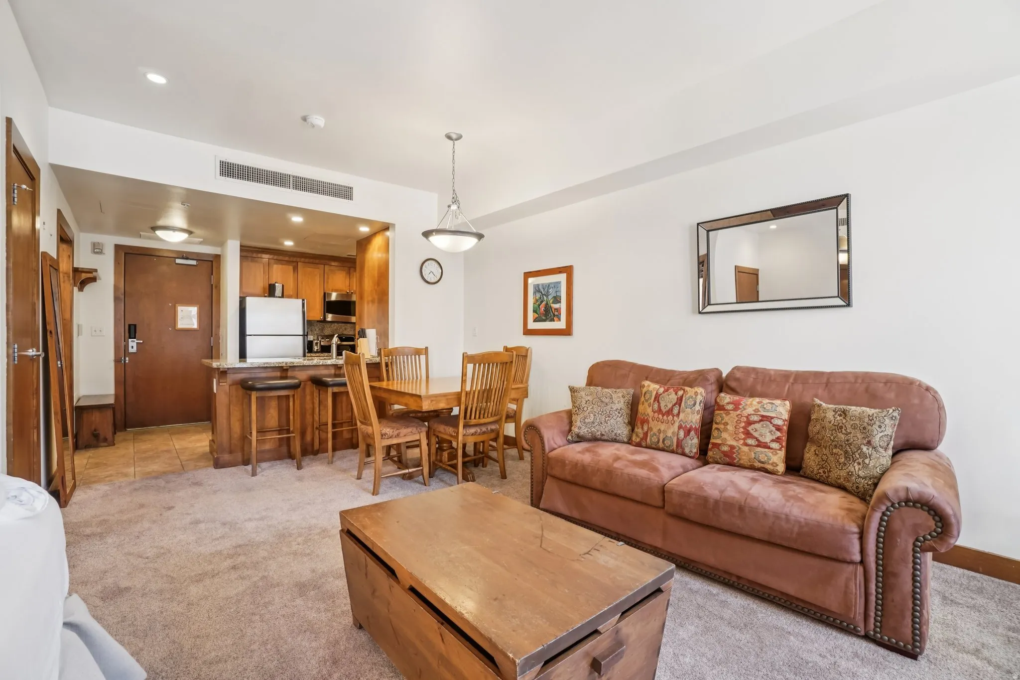 Living area featuring light colored carpet and recessed lighting