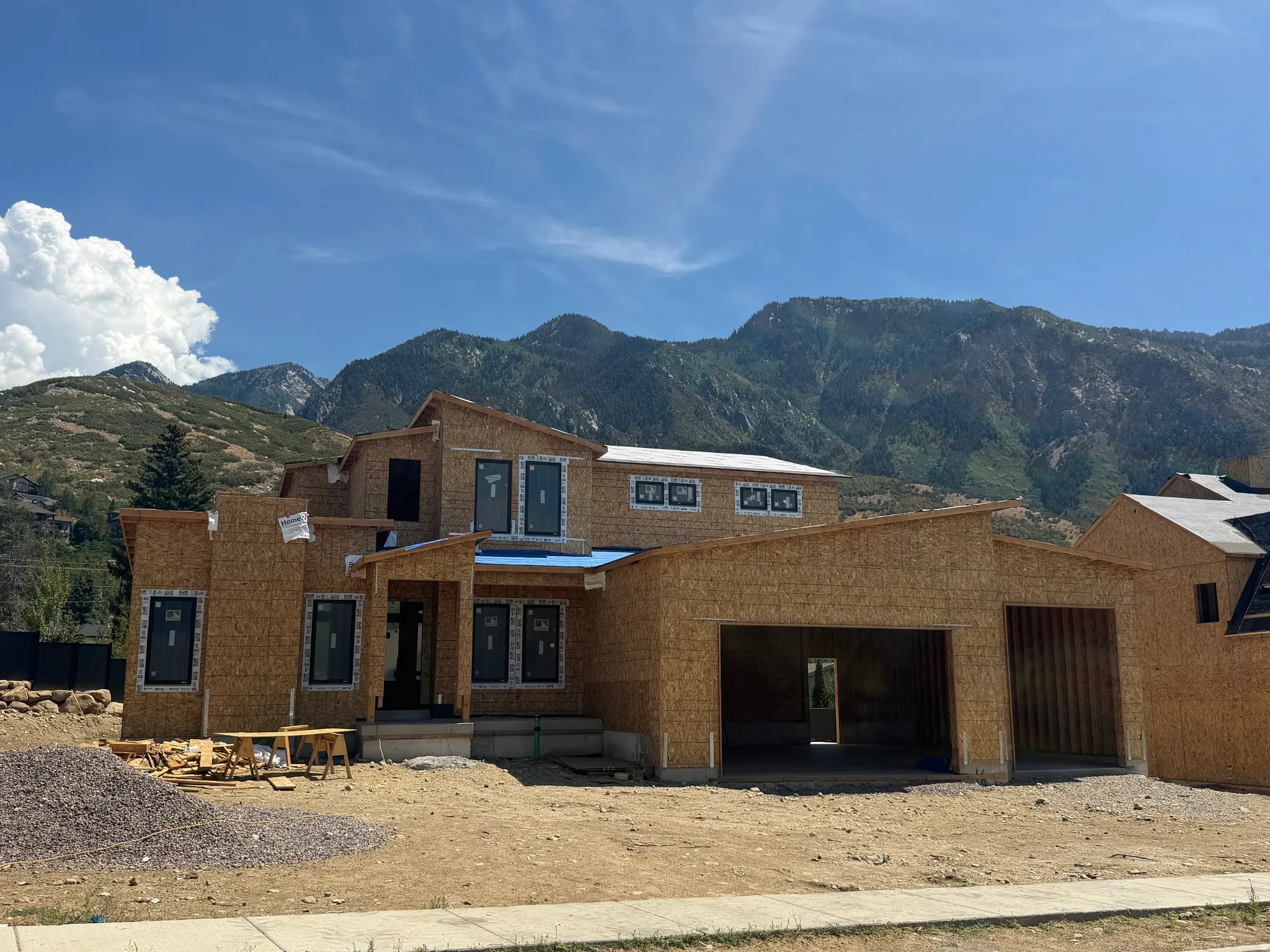 New construction framing with multiple window placements and an integrated garage