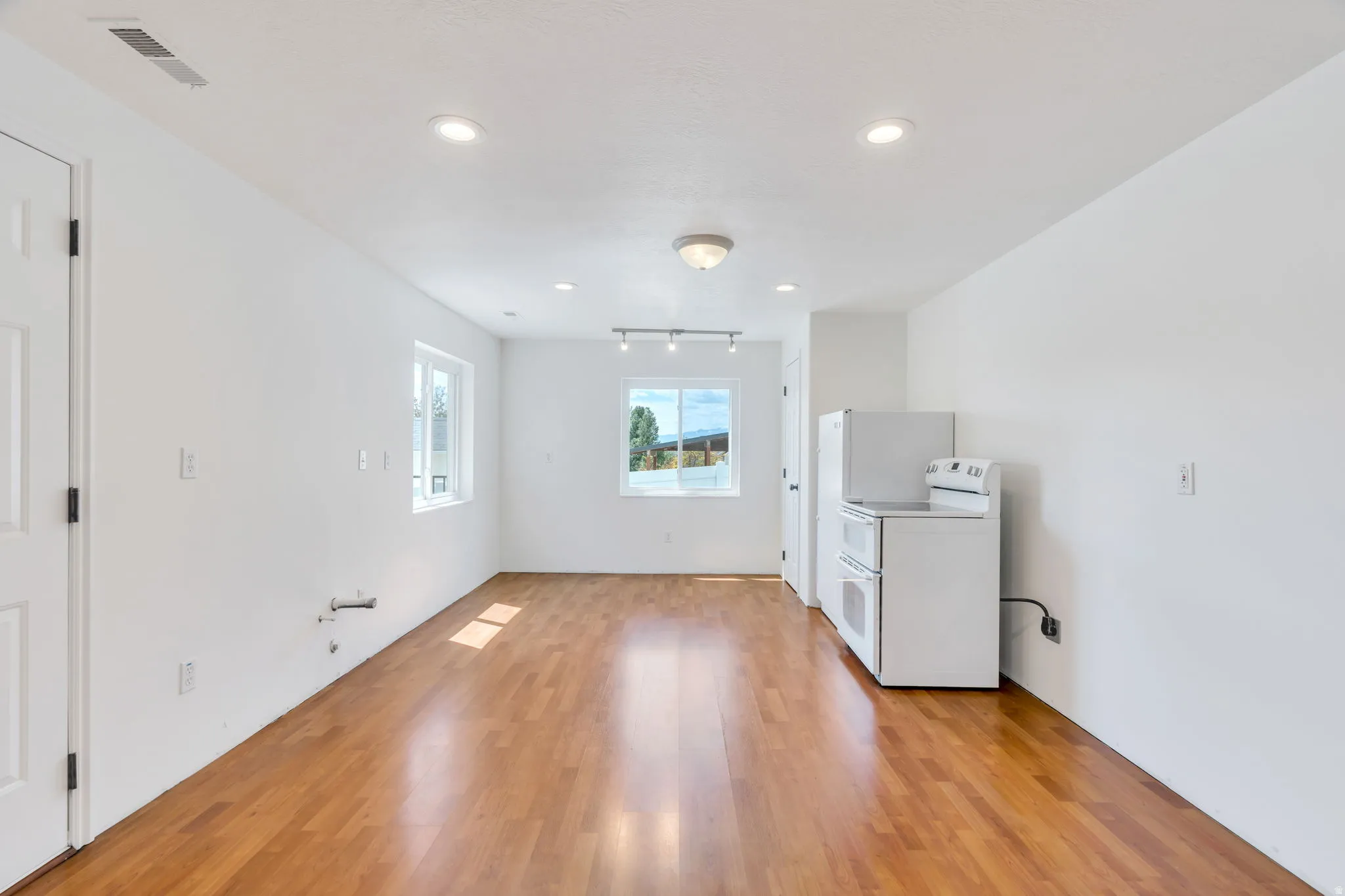 Basement great room plumbed for second kitchen with outside entry