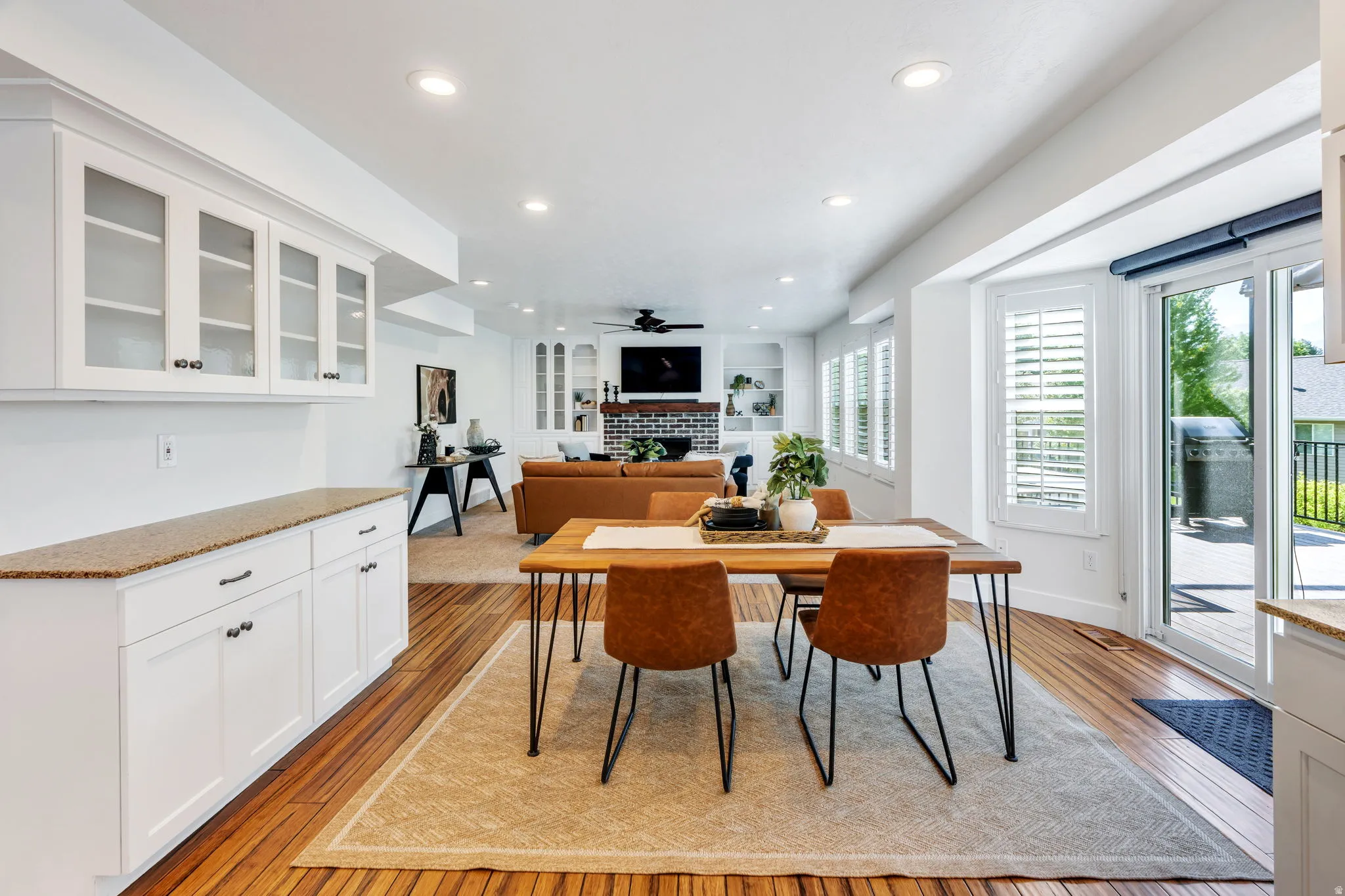 Semi formal dining area with glass sliding door to multi level decks and stairs to back yard