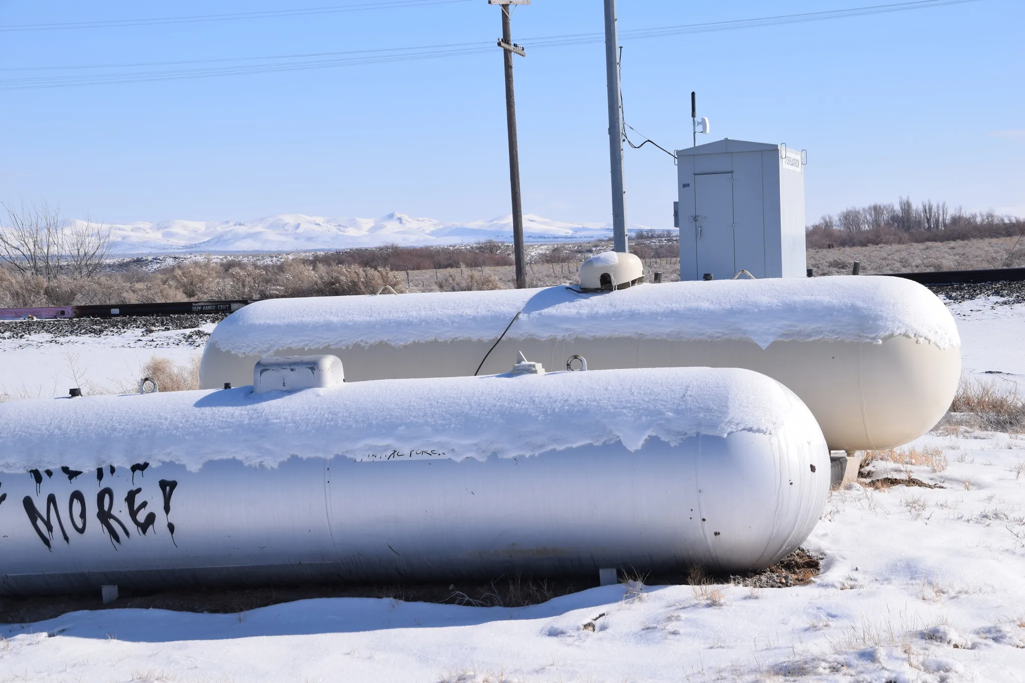 Exterior view of gas tank and a mountainous background