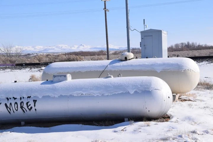 Exterior view of gas tank and a mountainous background