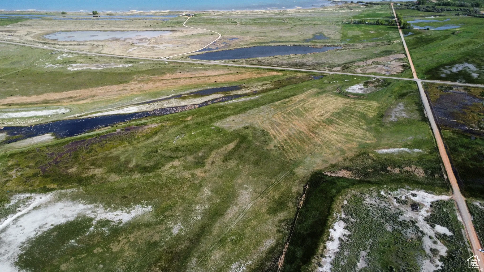 Aerial overview of property's location with a nearby body of water