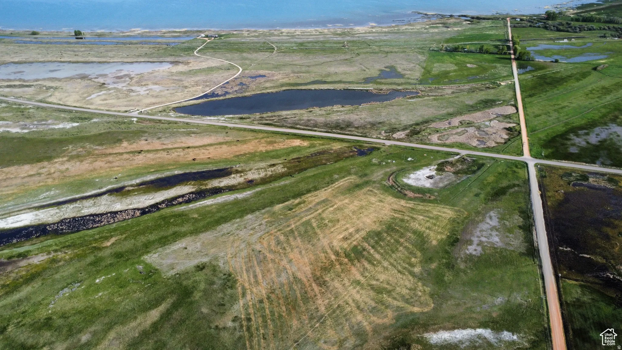 Aerial view of property and surrounding area featuring a large body of water