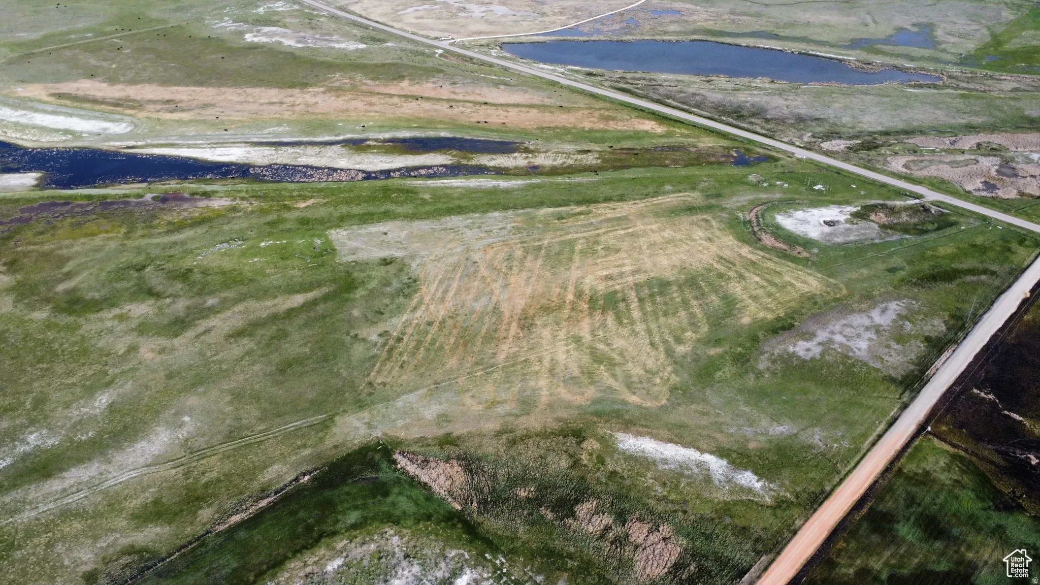 Aerial view of property and surrounding area featuring a nearby body of water