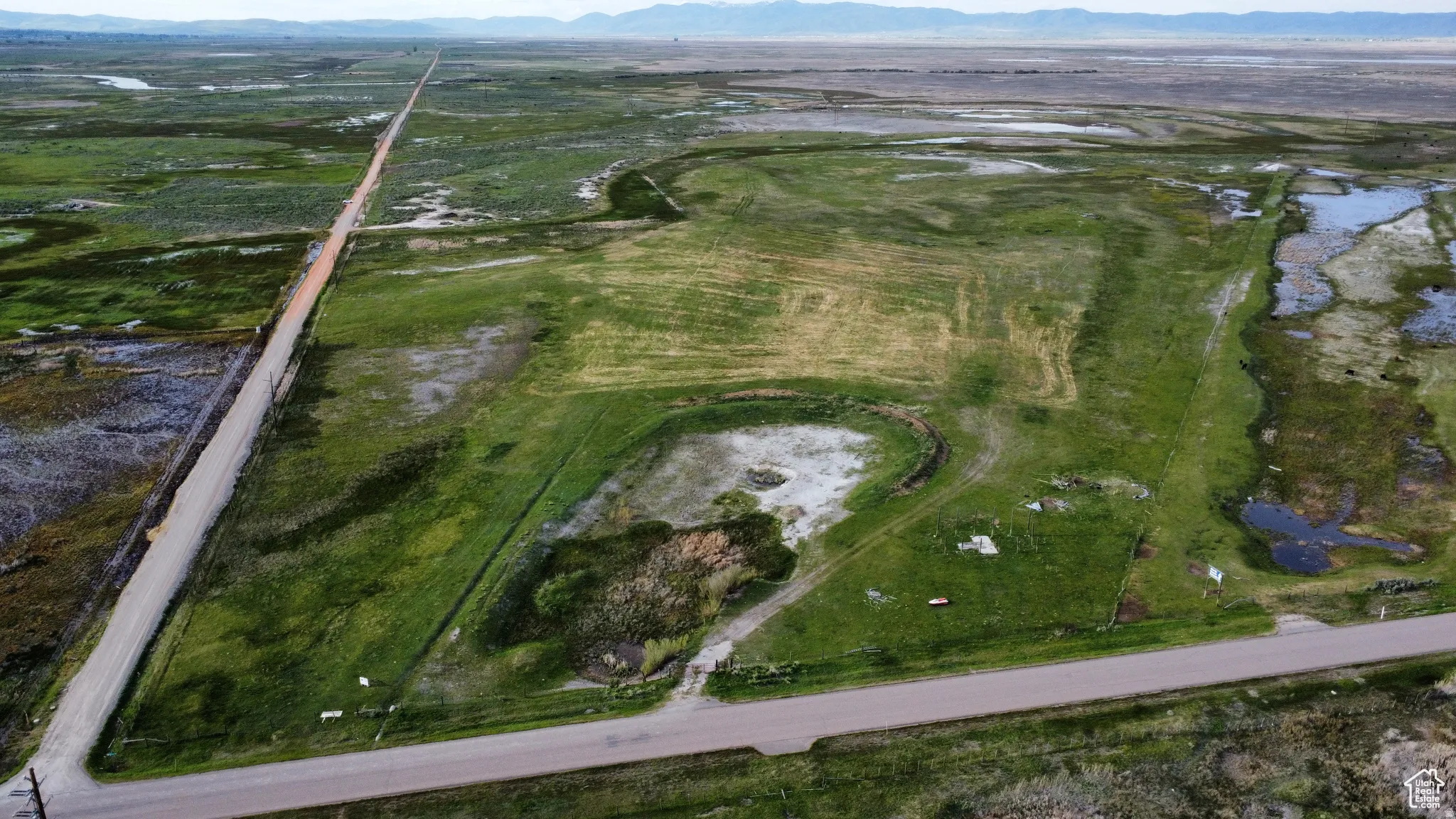 Aerial view of property and surrounding area featuring mountains
