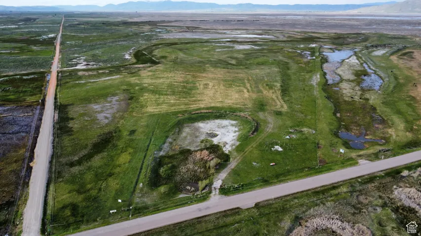 Aerial view of property and surrounding area featuring mountains