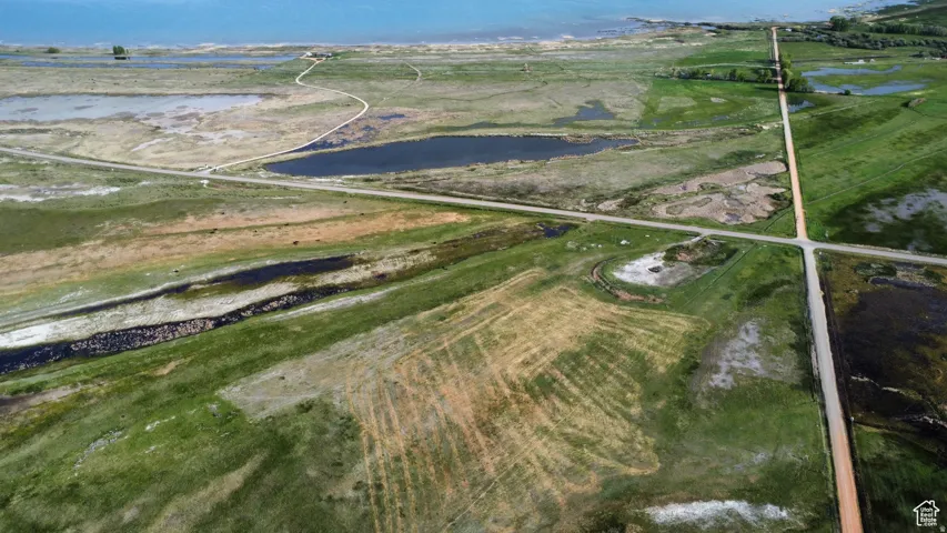Aerial view of property and surrounding area featuring a large body of water