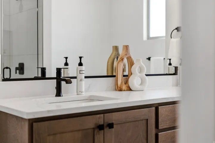 White countertop with integrated rectangular sink and matte black faucet