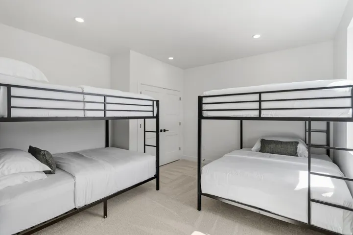 White walls with recessed lighting and light-toned carpet