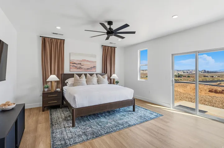 Light wood-finish flooring, white walls, recessed lighting, and a black ceiling fan