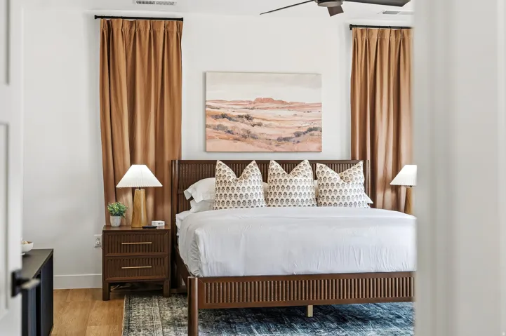 Wood-finish flooring, ceiling fan, and window treatments