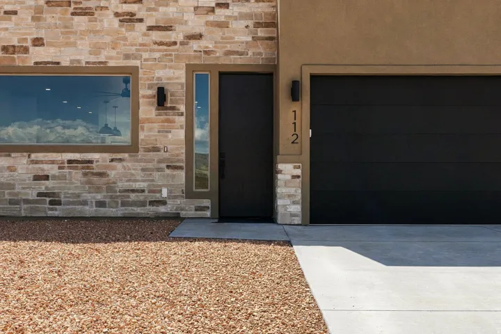 Stone veneer exterior facade with a large rectangular window