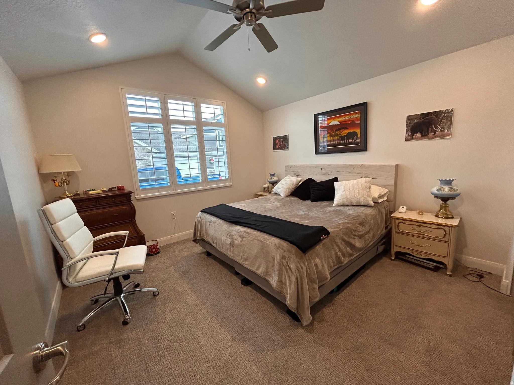 Carpeted bedroom with ceiling fan, vaulted ceiling, and recessed lighting