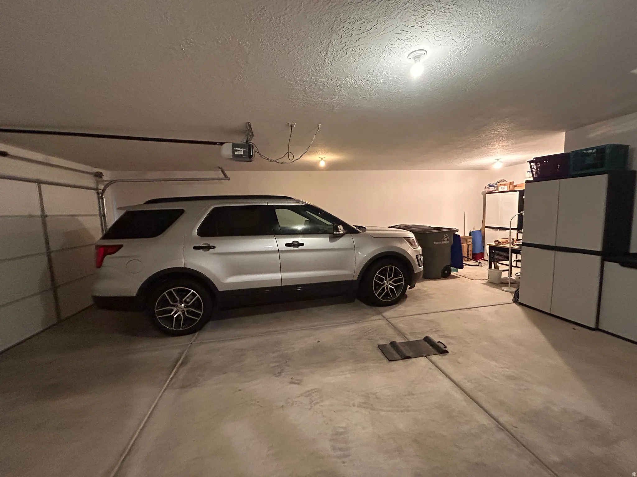 Garage with a garage door opener and extra depth