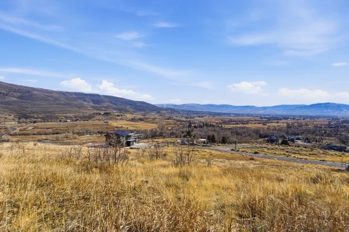 View of mountain backdrop with rural landscape