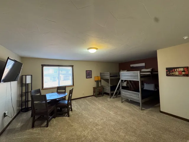 Carpeted dining room featuring baseboards
