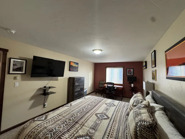 Carpeted bedroom featuring baseboards
