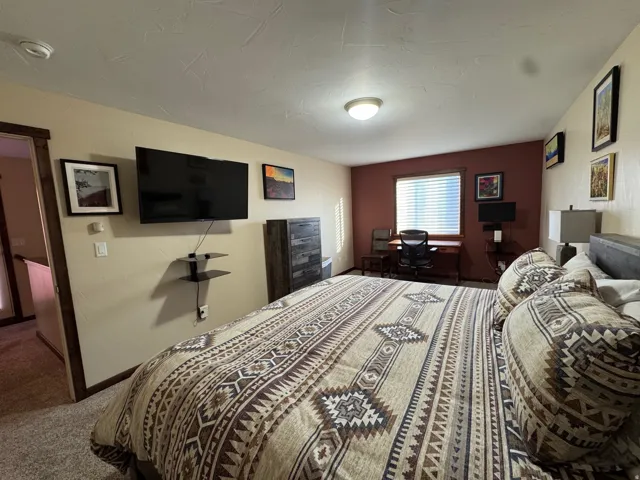 Carpeted bedroom featuring baseboards