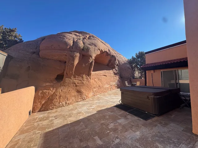 View of patio with a hot tub