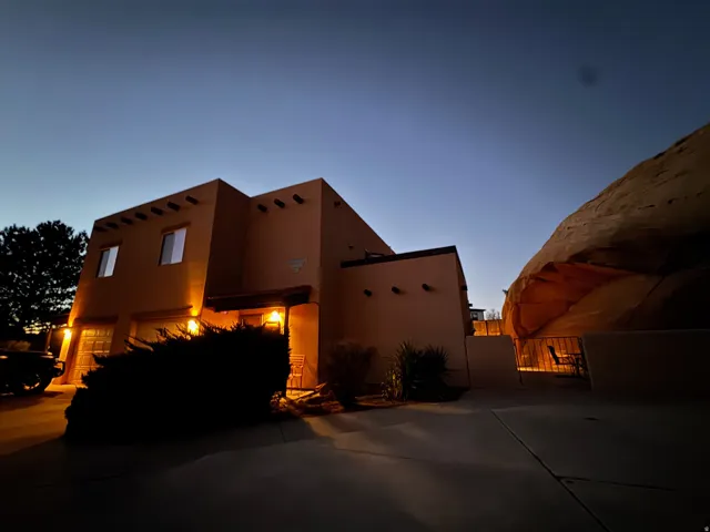 View of side of property featuring a gate and stucco siding