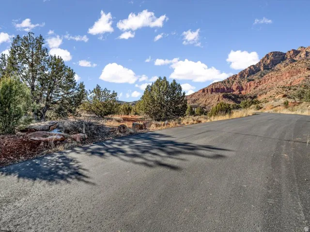 View of asphalt street featuring a mountain view