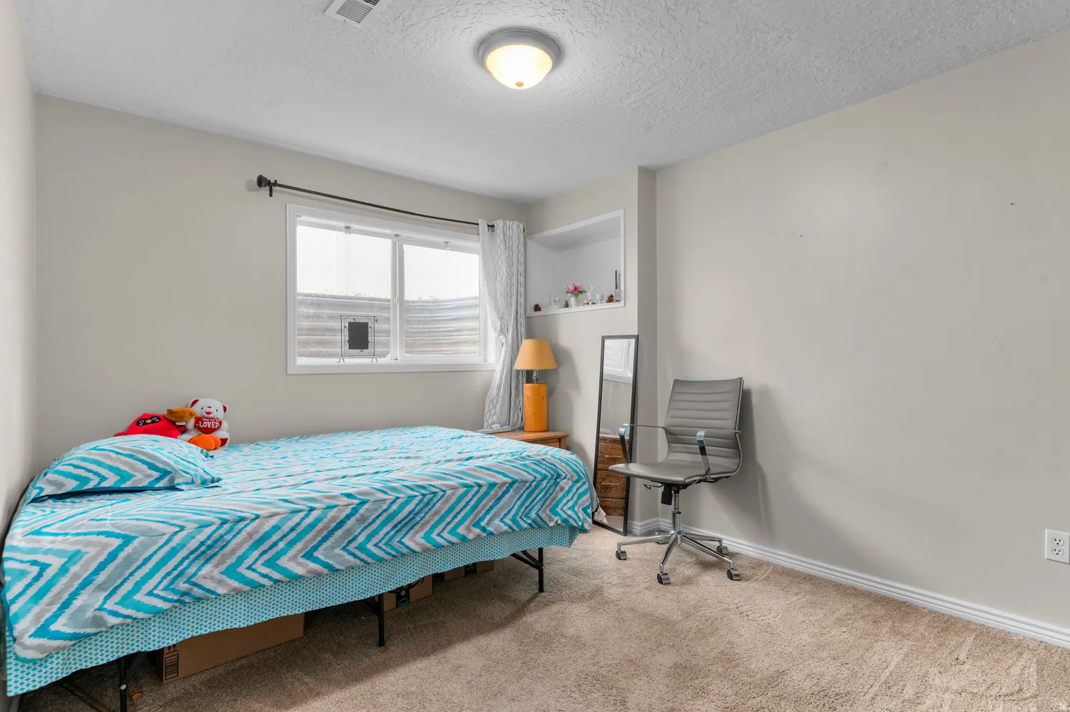 Bedroom featuring a textured ceiling and carpet