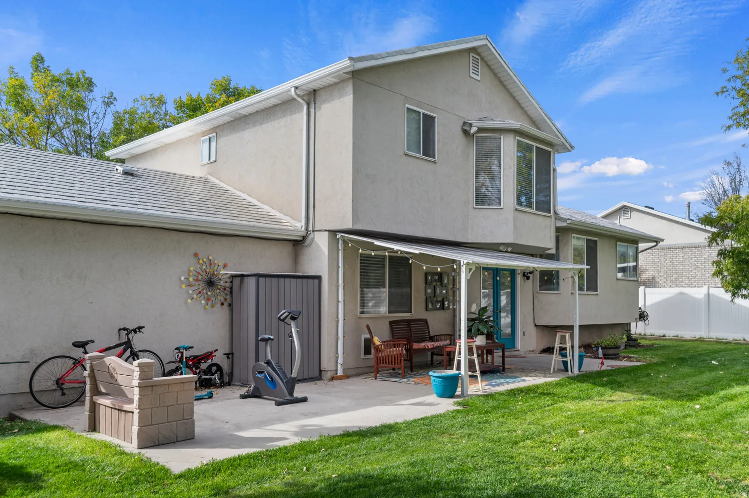 Rear view of property with a patio and stucco siding