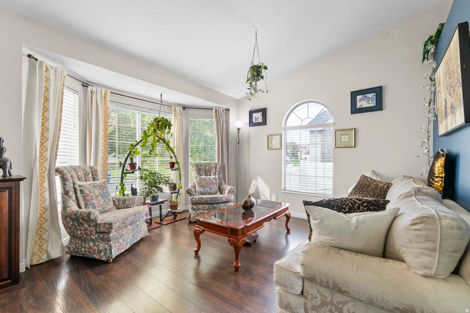 Living room featuring lofted ceiling and wood-type flooring
