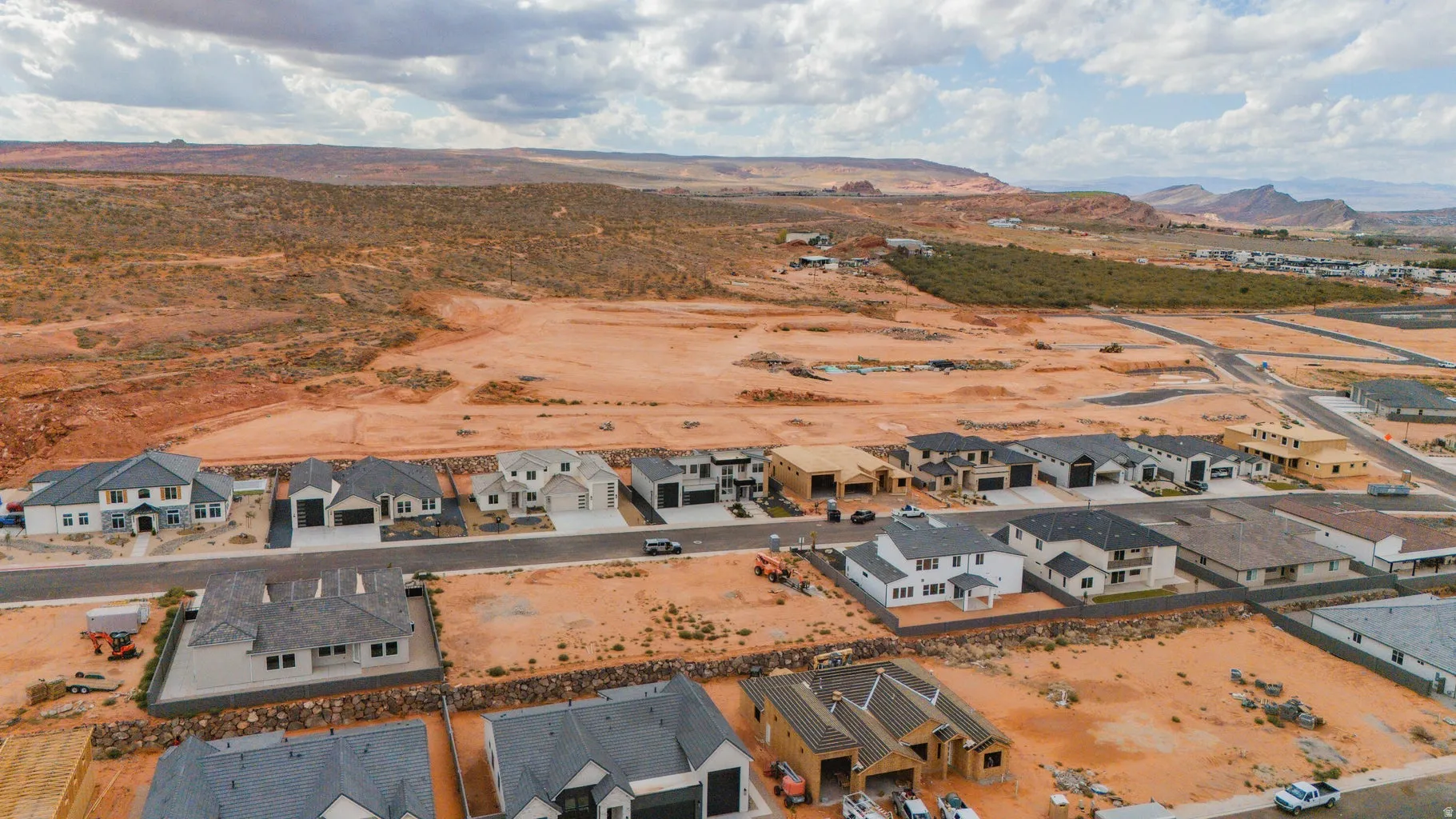Aerial view of residential area with a mountain backdrop and a desert landscape