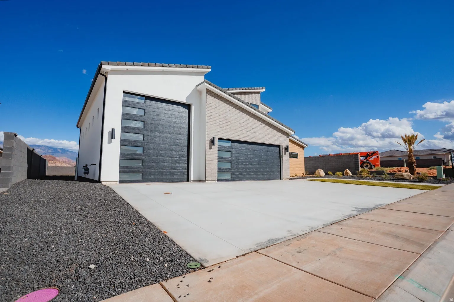 Garage featuring concrete driveway