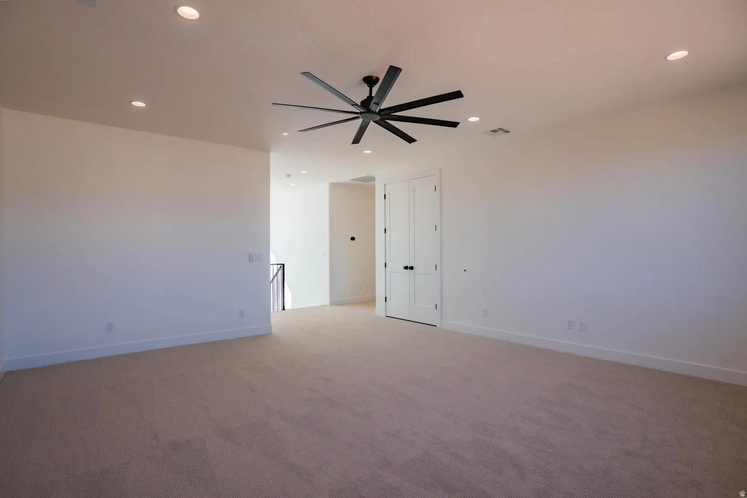 Spare room with light carpet, recessed lighting, and a ceiling fan