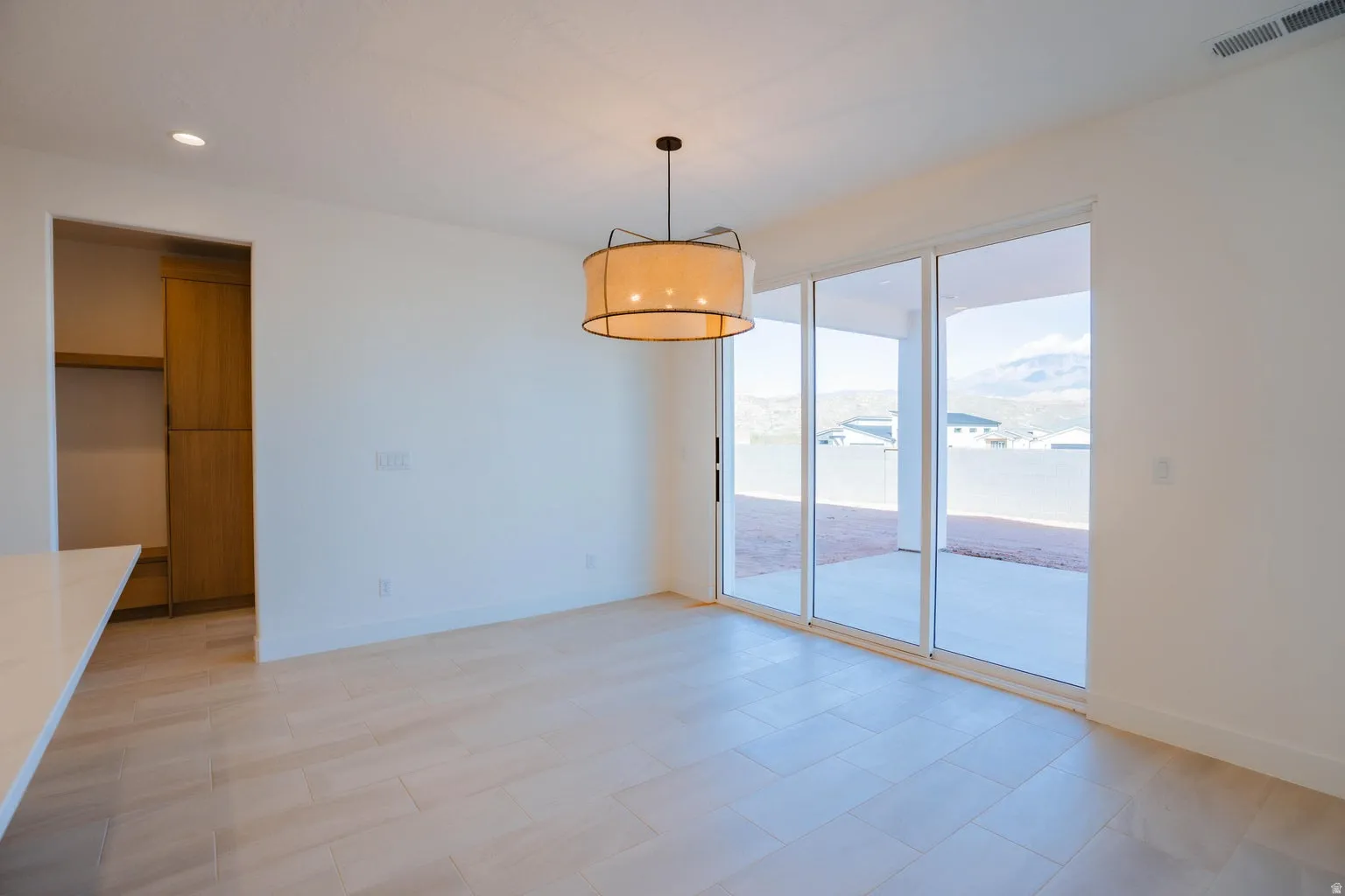 Unfurnished dining area with recessed lighting and a mountain view