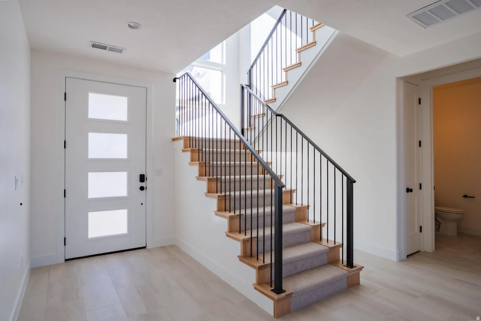 Entryway featuring healthy amount of natural light and stairway