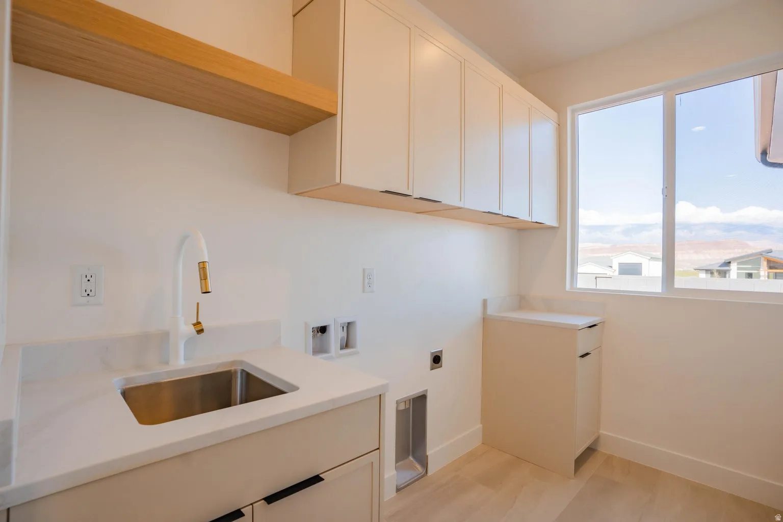 Laundry room featuring washer hookup, cabinet space, hookup for an electric dryer, and light wood-style flooring