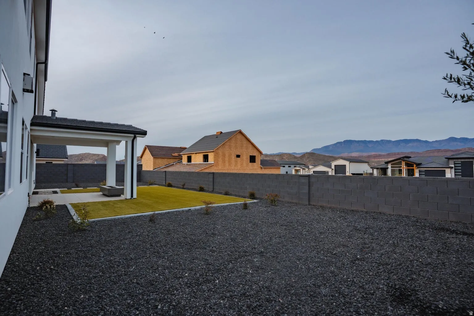 Fenced backyard with a residential view, a patio area, and a mountain view