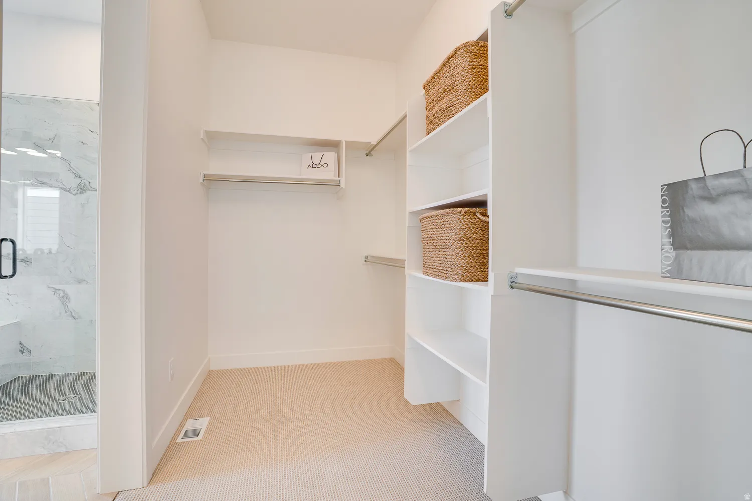 Spacious closet with light colored carpet