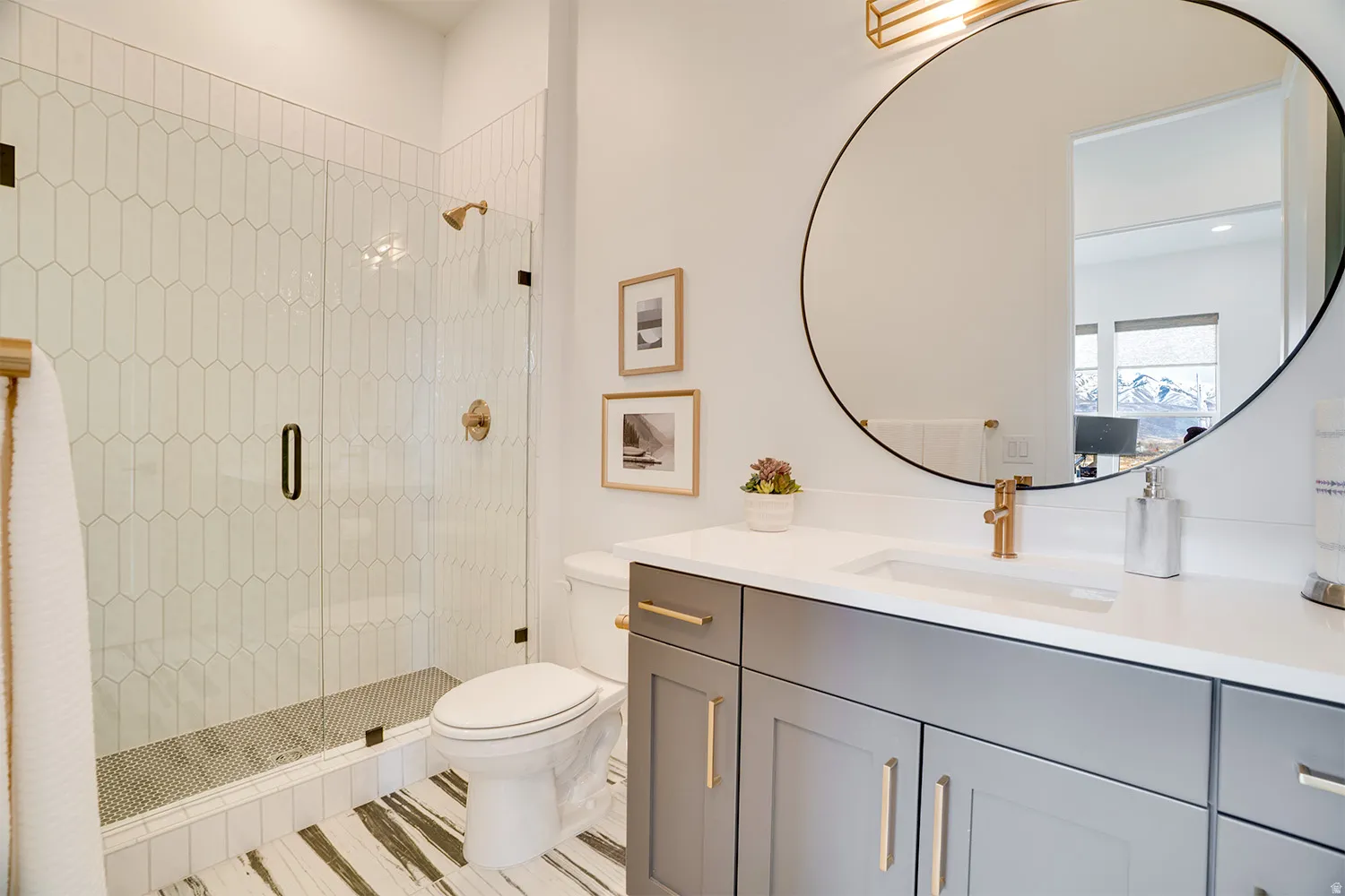 Bathroom featuring a stall shower and vanity