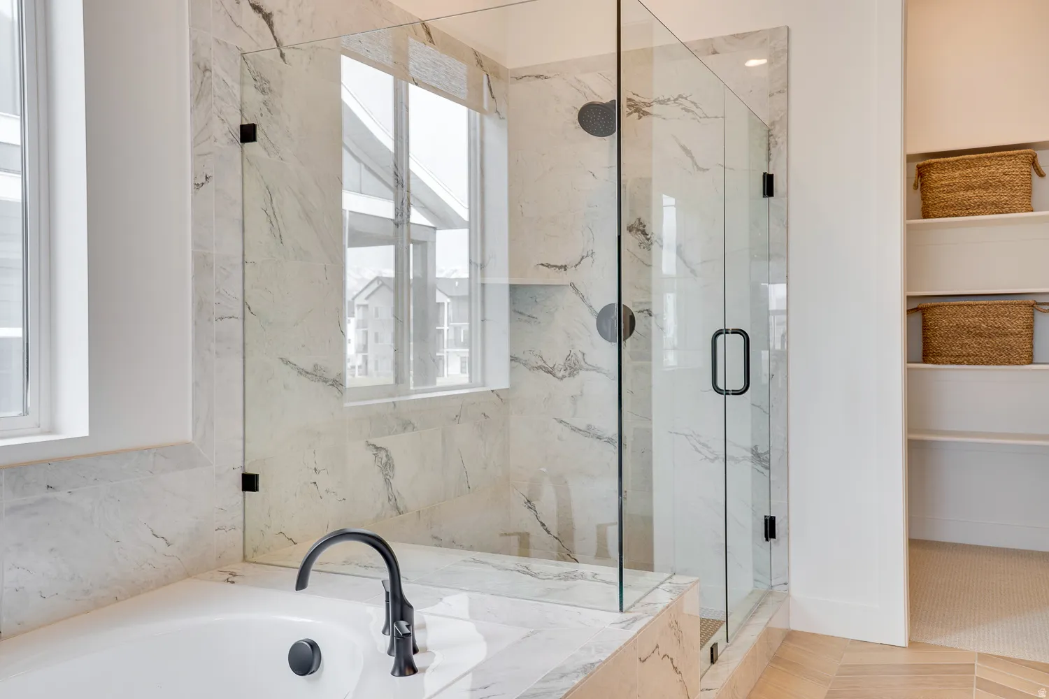 Bathroom featuring a marble finish shower and a garden tub