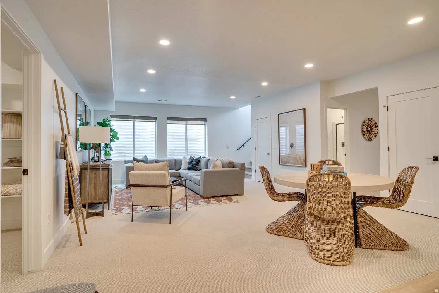 Dining area featuring light colored carpet, recessed lighting, and stairway