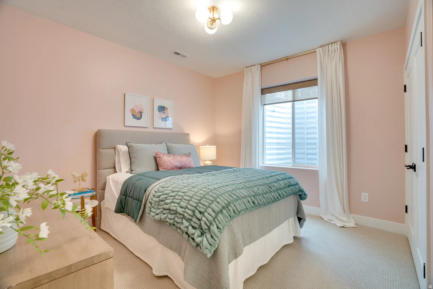 Bedroom with carpet floors and a textured ceiling