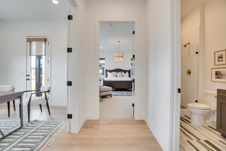 Corridor with light wood finished floors, healthy amount of natural light, and recessed lighting