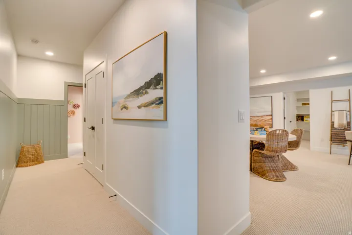 Hallway with light carpet and recessed lighting