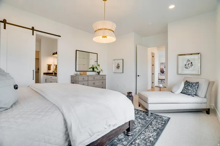 Bedroom featuring a barn door, carpet flooring, connected bathroom, and recessed lighting