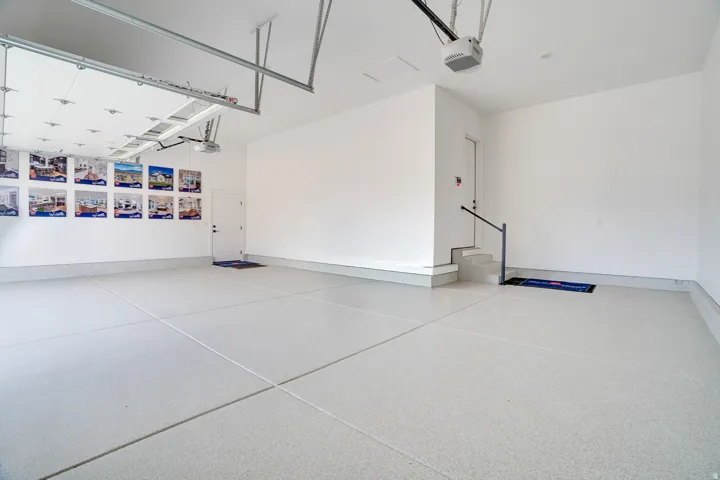 Garage featuring a garage door opener and baseboards