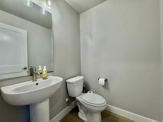 Bathroom featuring baseboards and wood finished floors