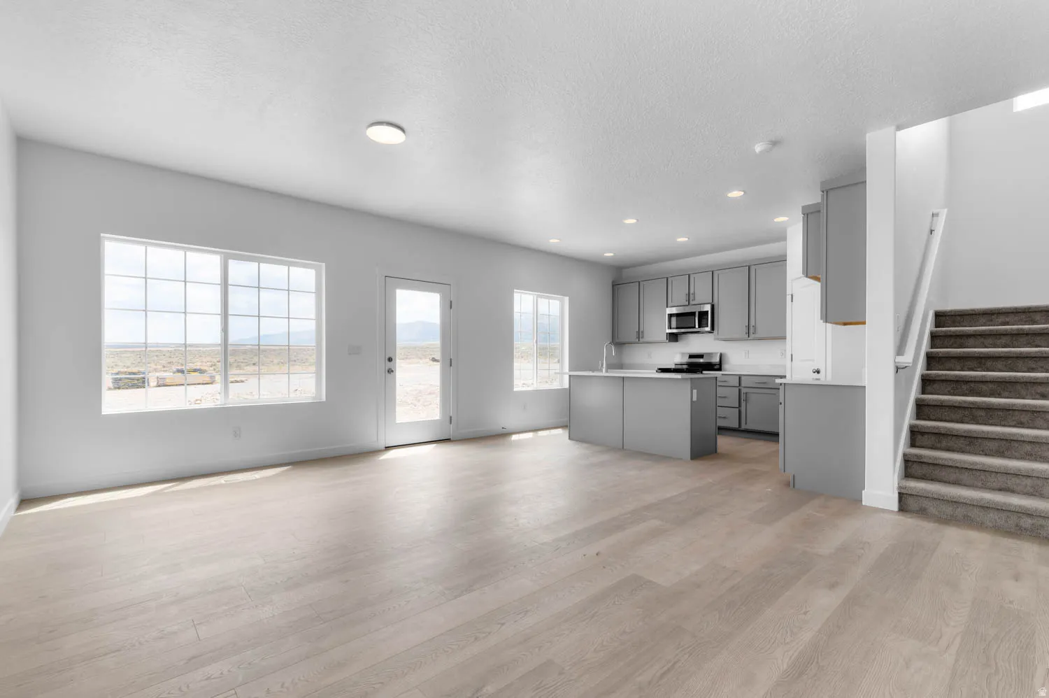 Open concept living space featuring wood-finish flooring