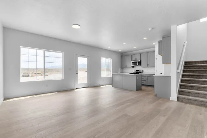 Open concept living space featuring wood-finish flooring