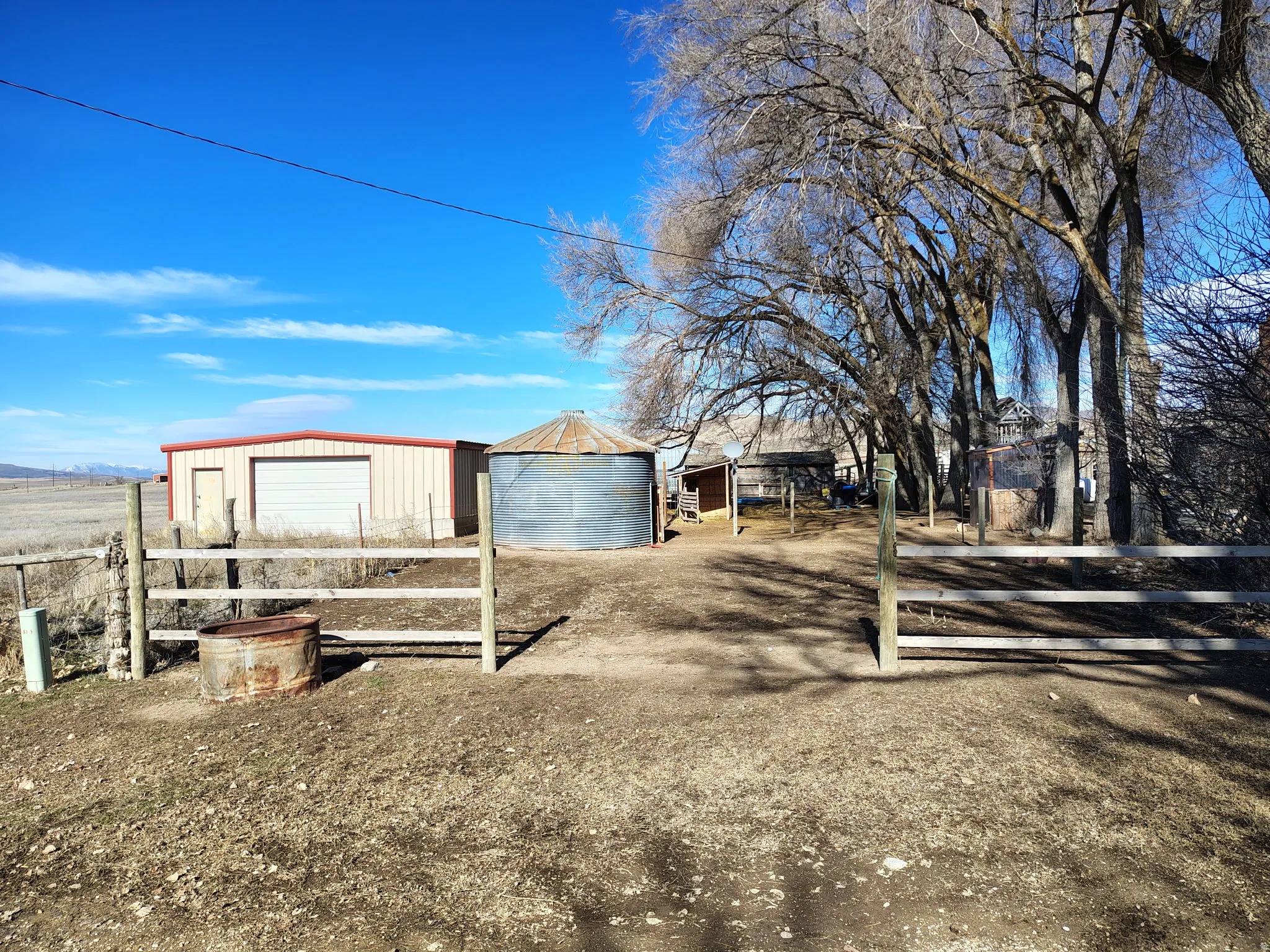 View of yard with a detached garage and an outbuilding